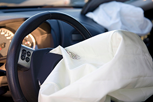 exploded airbag on the steering wheel of a car