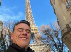 Image of Juan Roque in front of Eiffel Tower for Who is Juan Roque? blog post