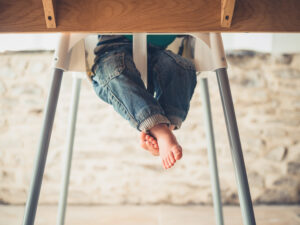 image of baby feet dangling in highchair for boon flair highchair recall blog