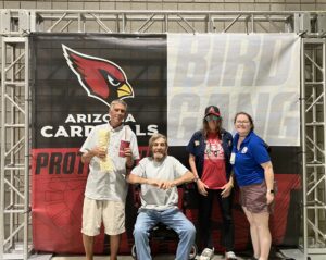 image of individuals posing at Arizona Cardinals game for cardinals tickets to veterans blog post