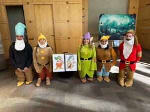 group of staff members wearing seven dwarves costumes for Phillips Law Group celebrates Halloween blog