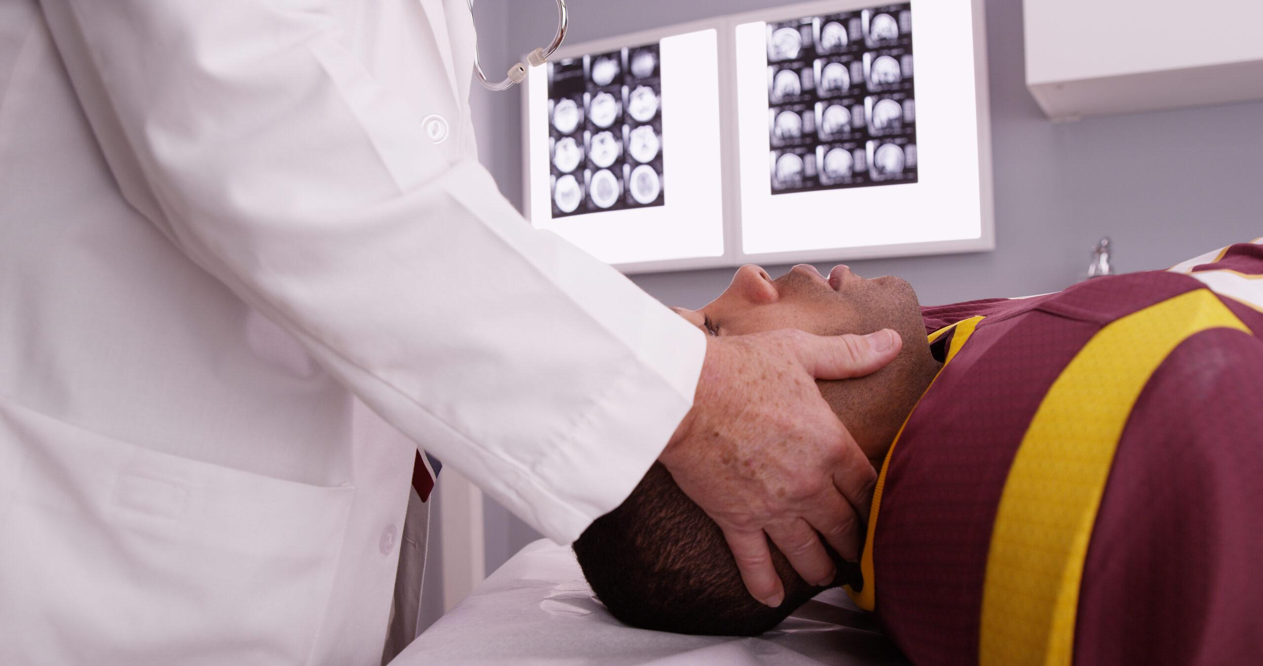 football player being examined by doctor for brain injury and sports blog post