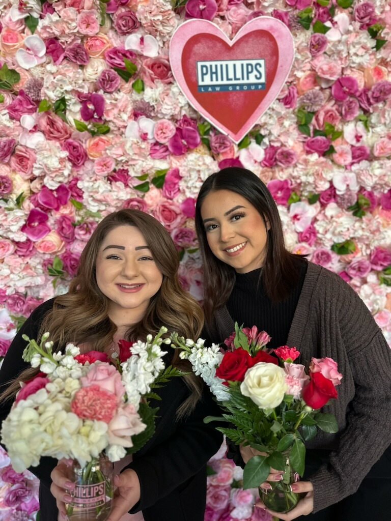 two employees at the phillips law group pop-up flower shop