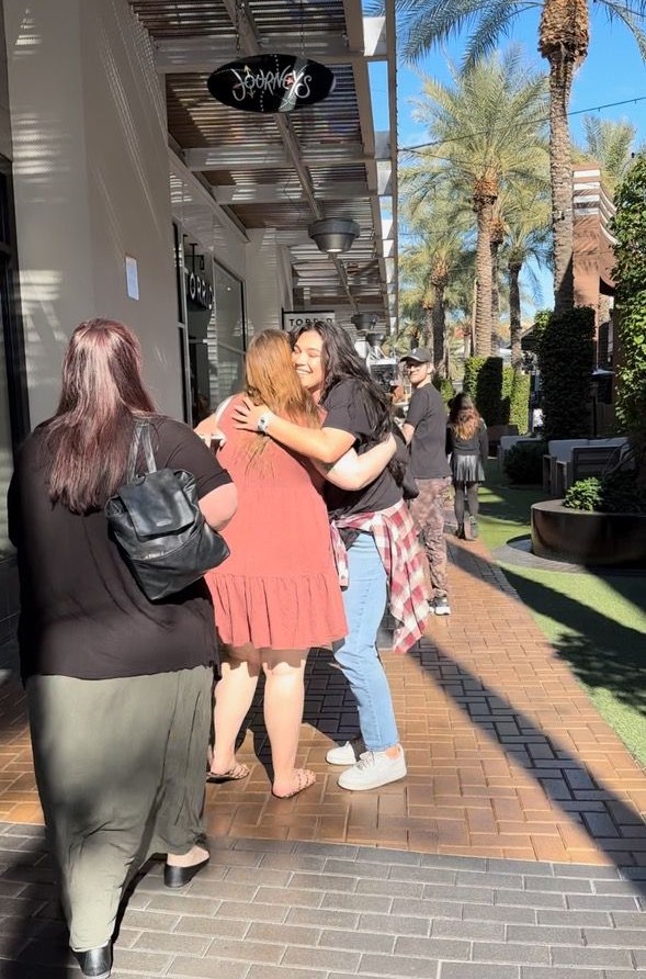 two women hugging in tempe marketplace