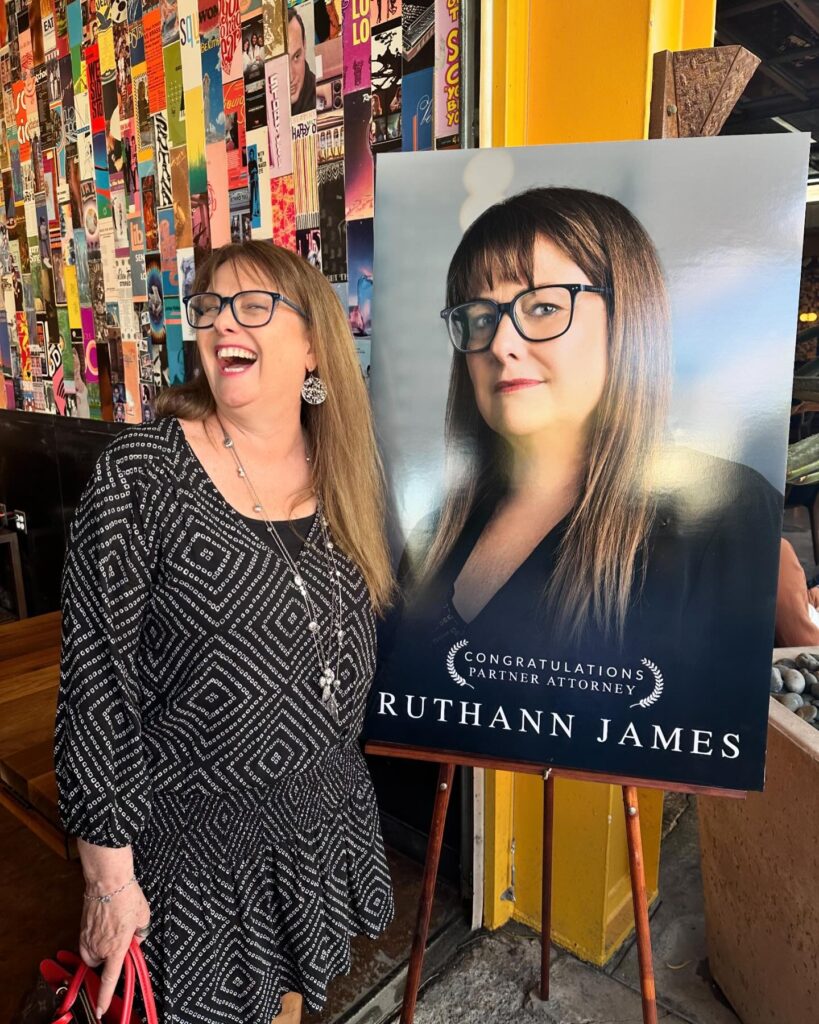 ruthann james with a photo of herself after being named partner attorney at phillips law group