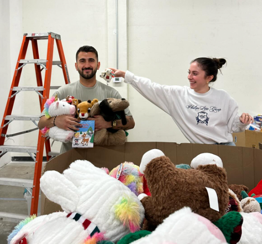 two volunteers participating in toy organization at the foster alliance