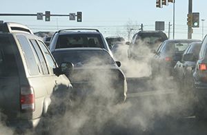 cars with smoke emissions in a street