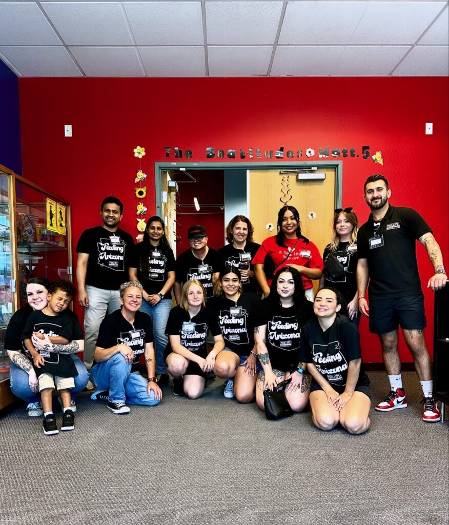 group photo of several volunteers posing at a new leaf kids event