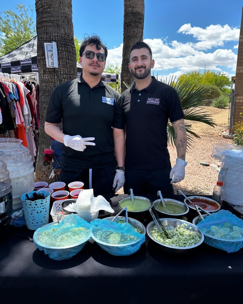 two volunteers at event to help the homeless at a new leaf