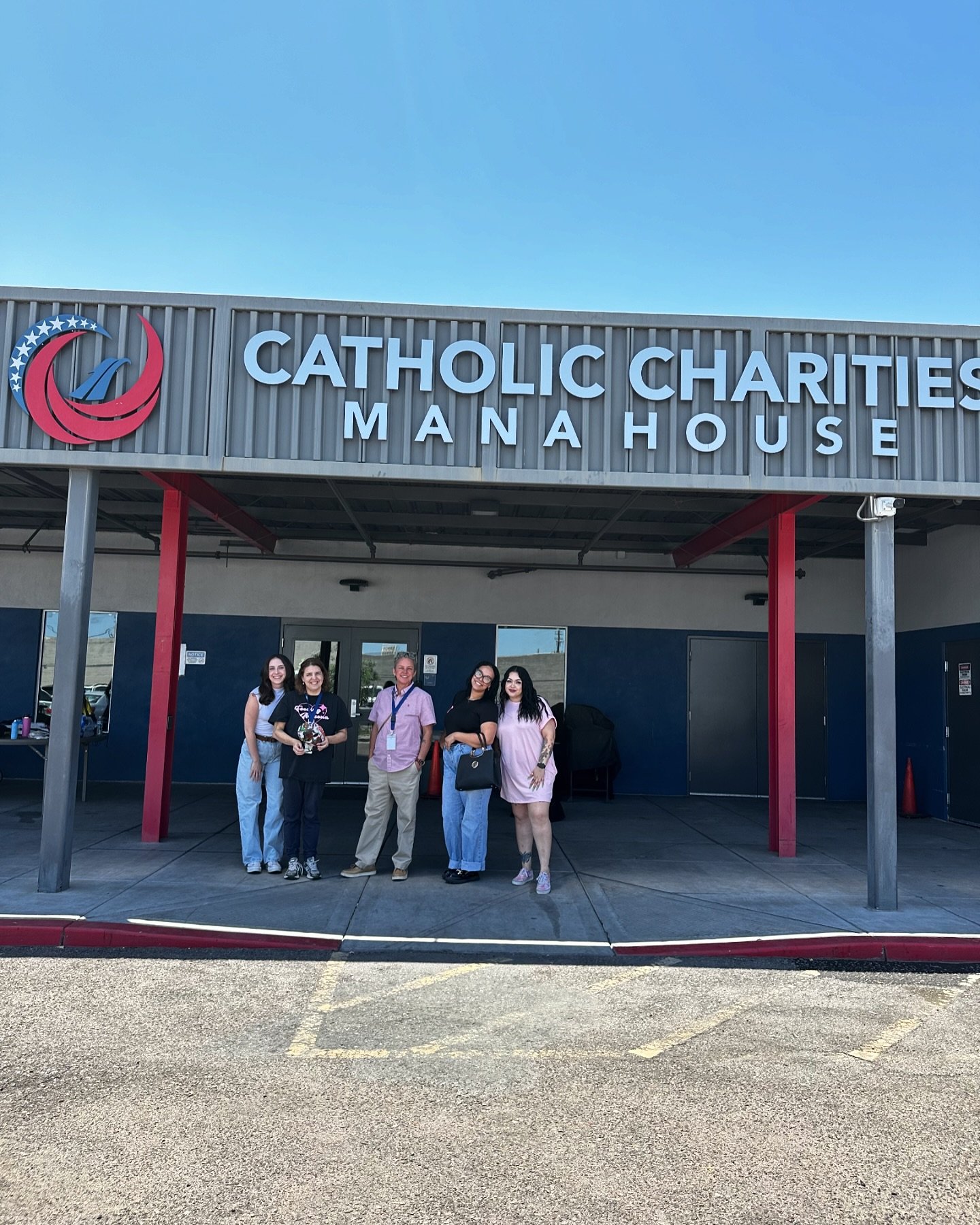 volunteers posing in front of mana house before mana house party for veterans in late may 2024