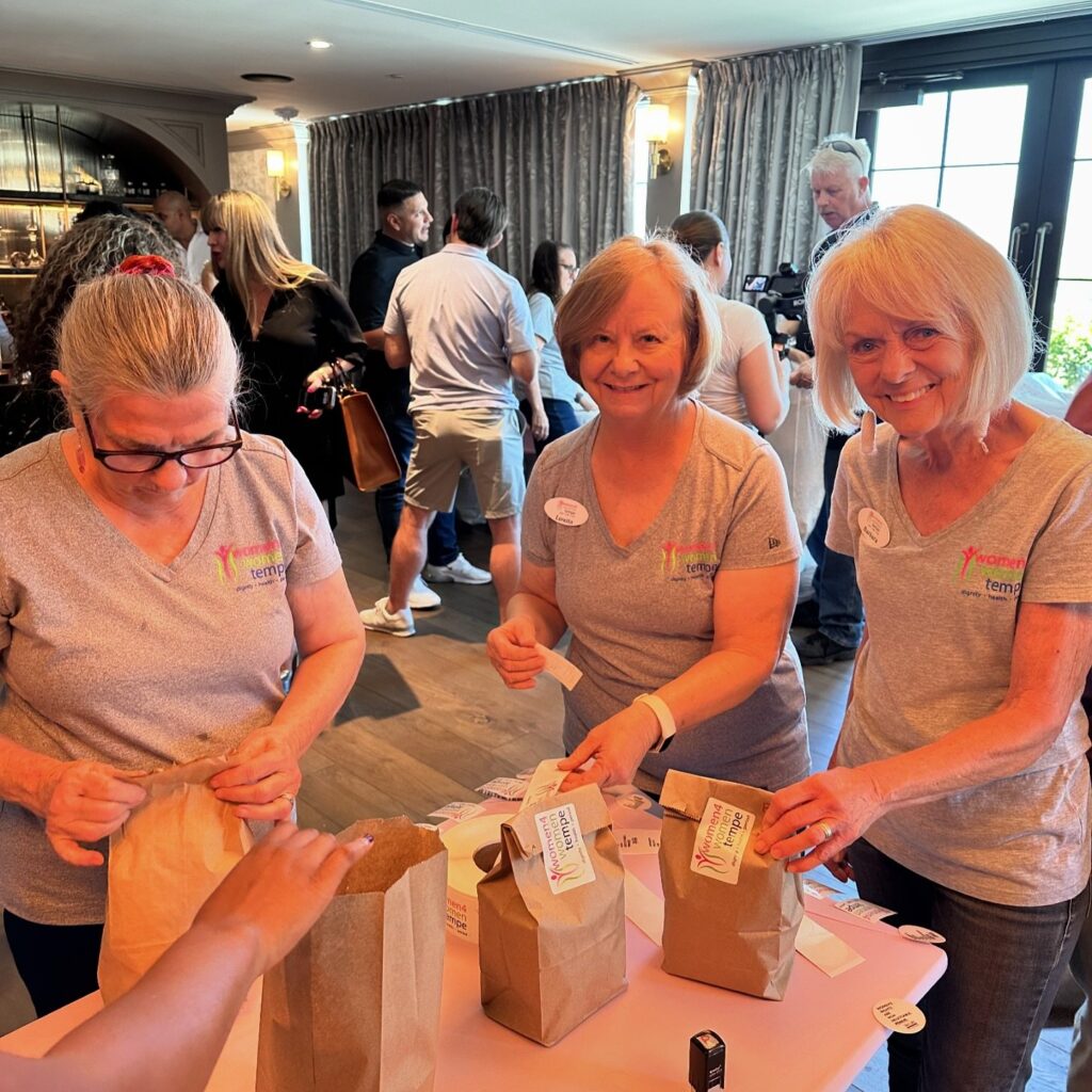 three volunteers pictured at the women4women feminine hygiene kit packing party