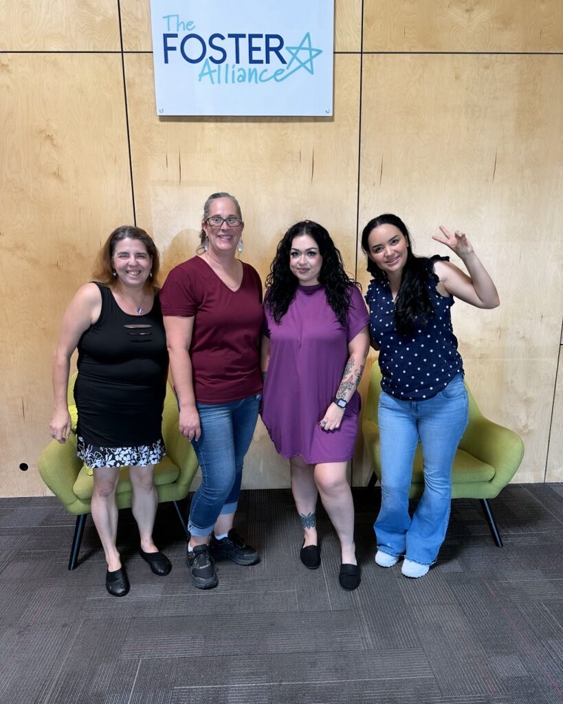 image of four volunteers outside the foster alliance for community outreach in september blog