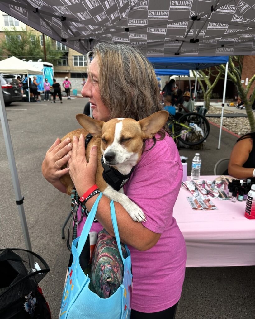 woman holding dog at feeding arizona event