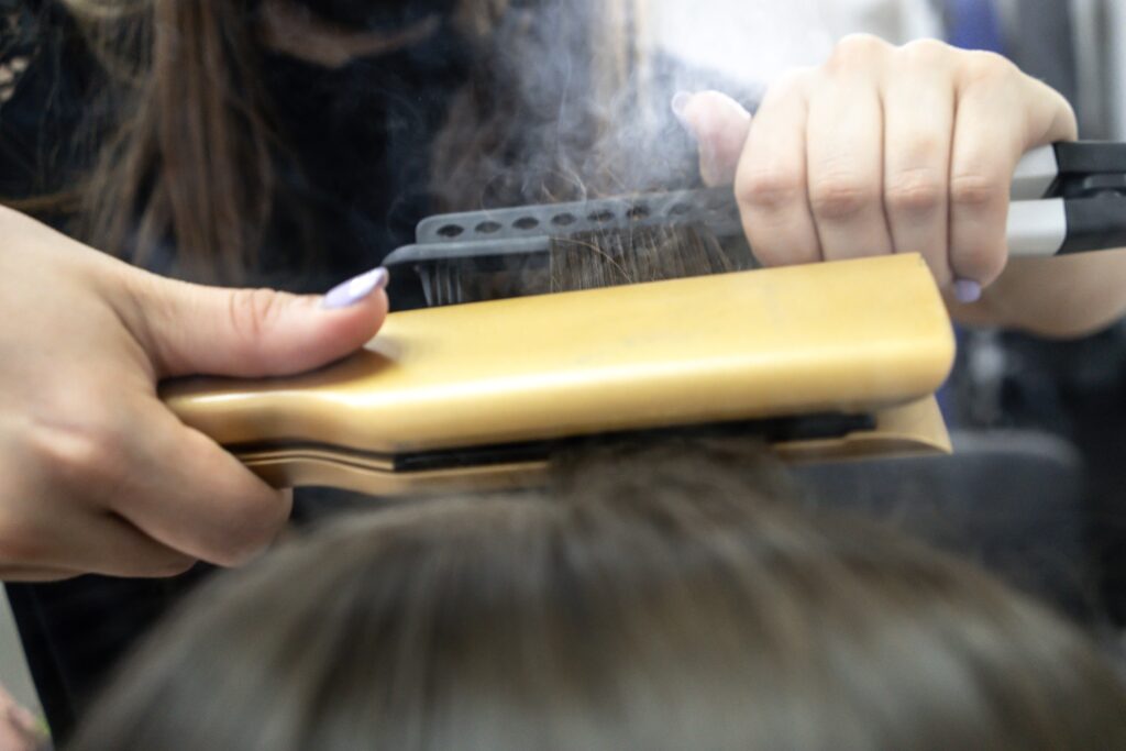 image of hair being straightened