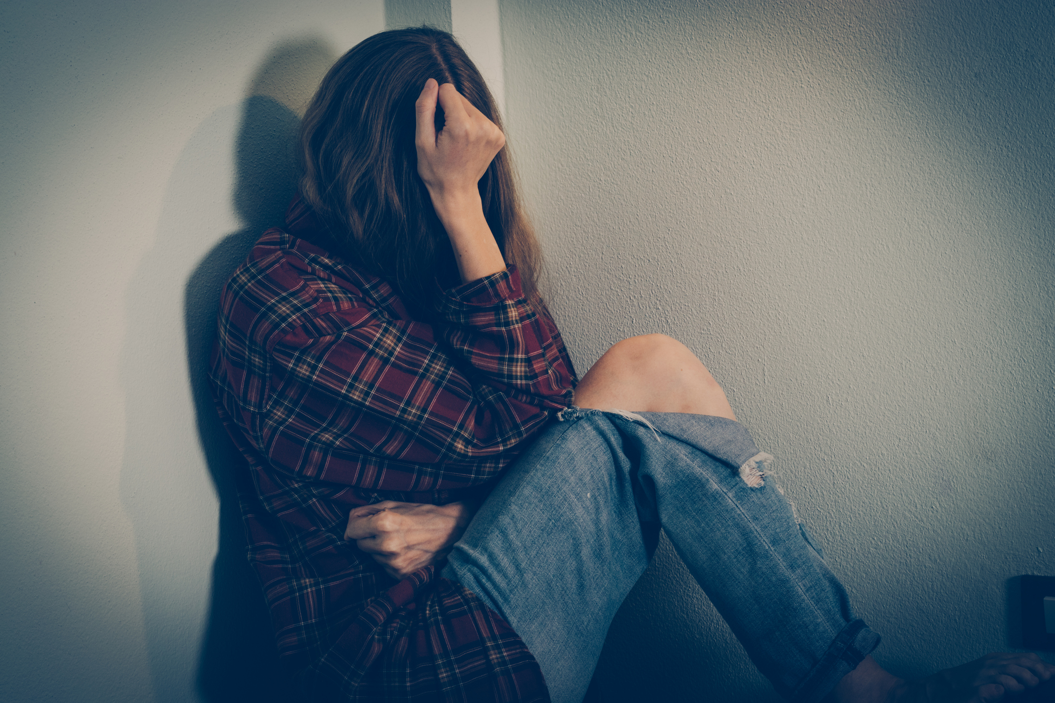 Depressed woman covering her face