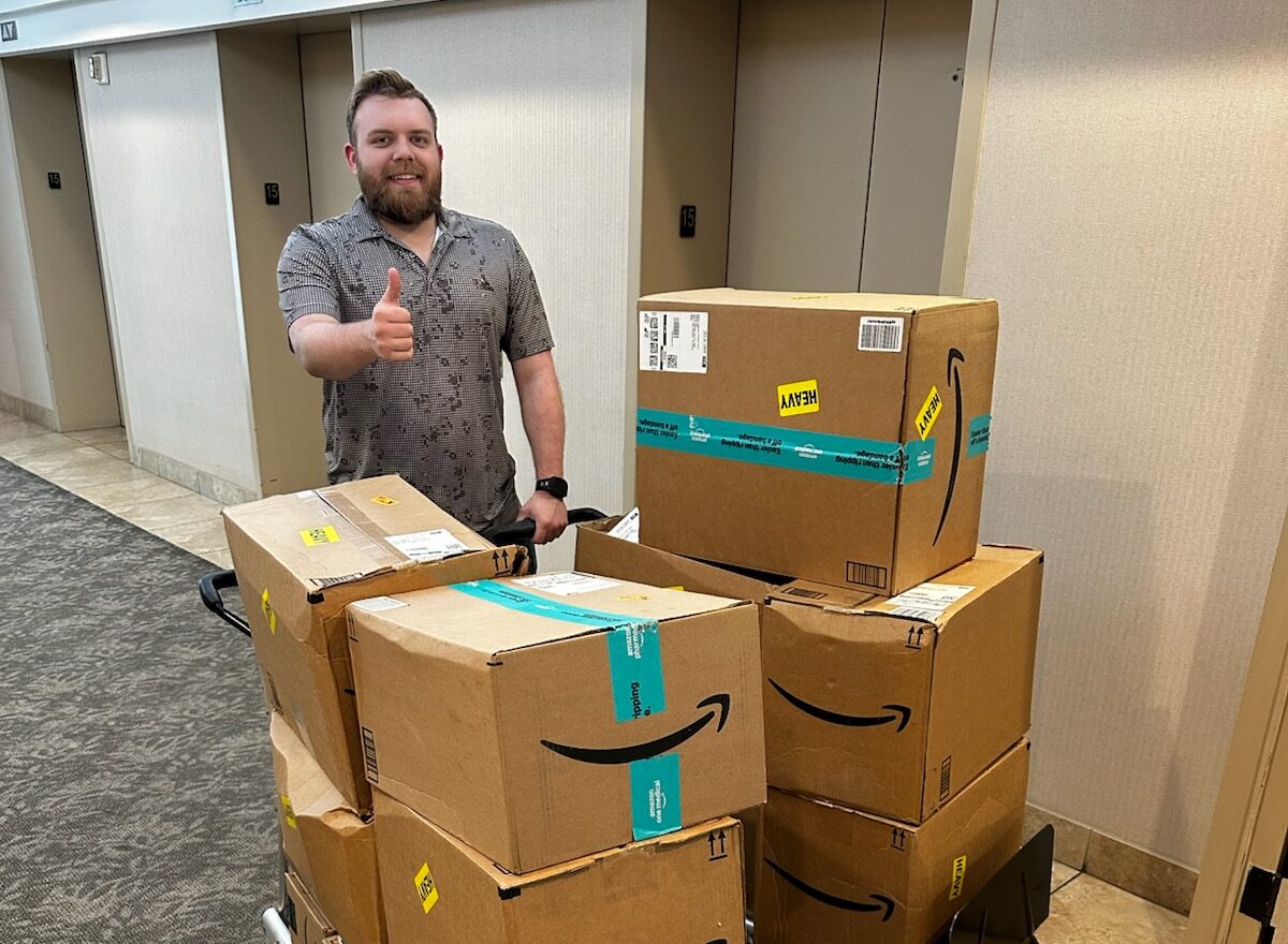 man with eight boxes ready to be donated