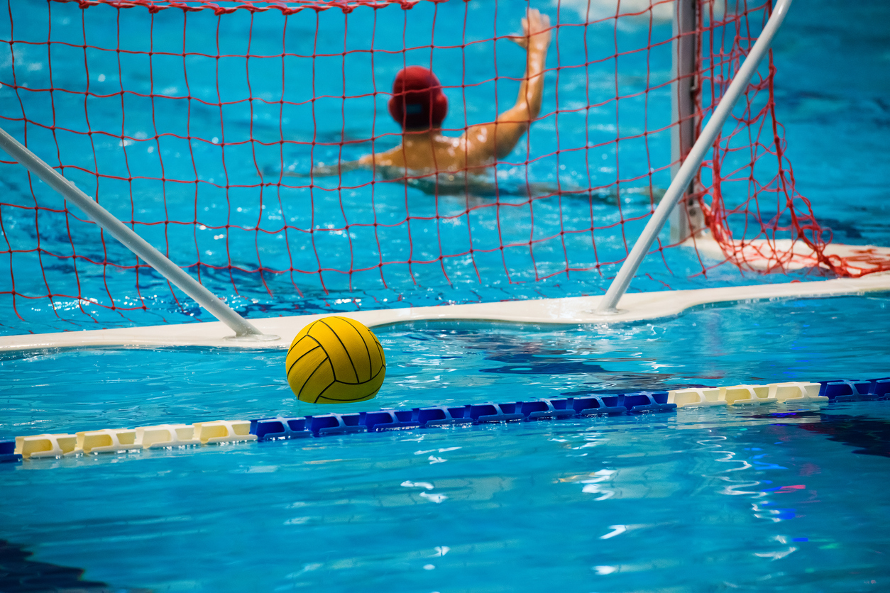 Water polo action in a swimming pool