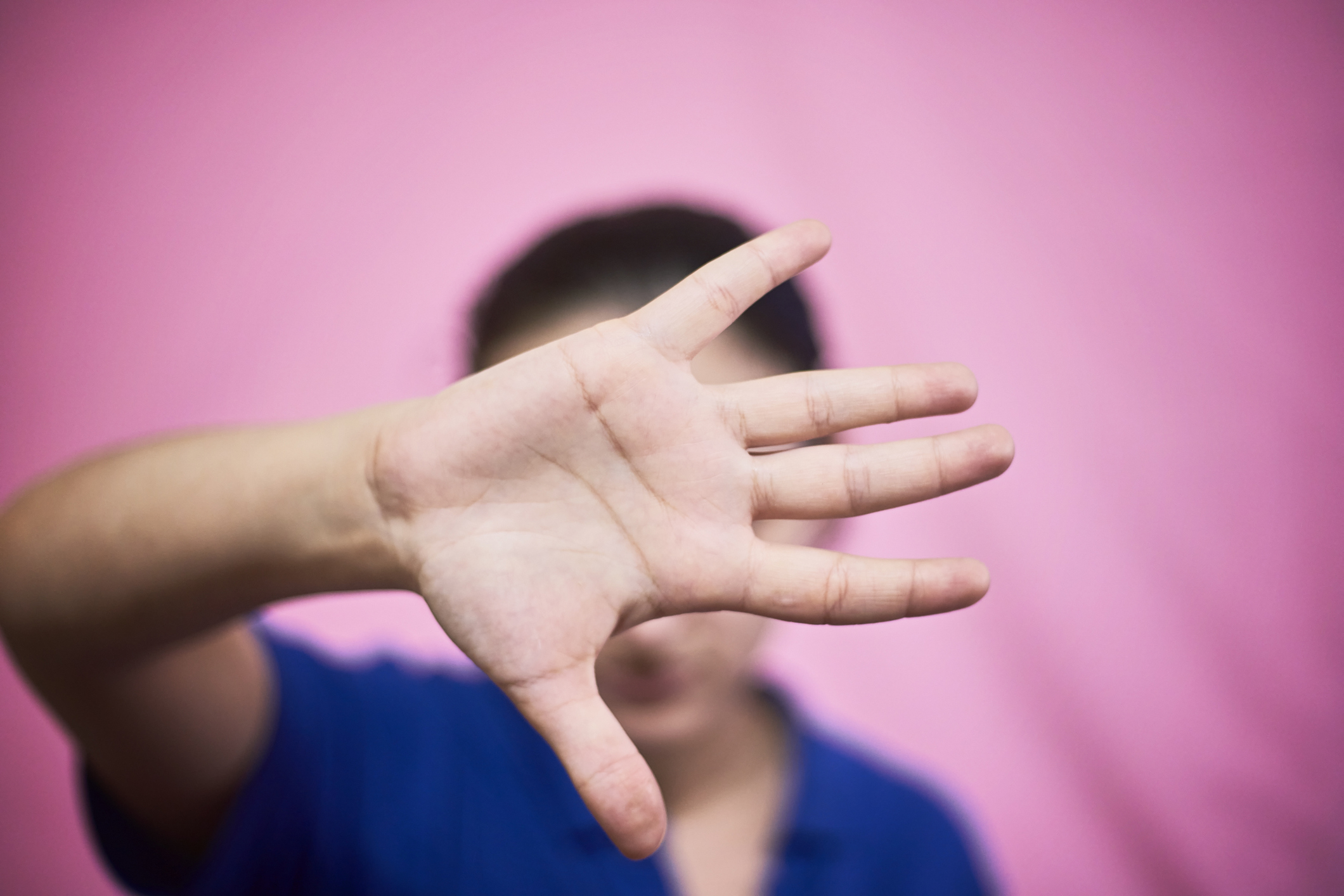 Stop domestic violence and abuse concept. Woman saying stop with hands. Hand gesture - Stop violence against women