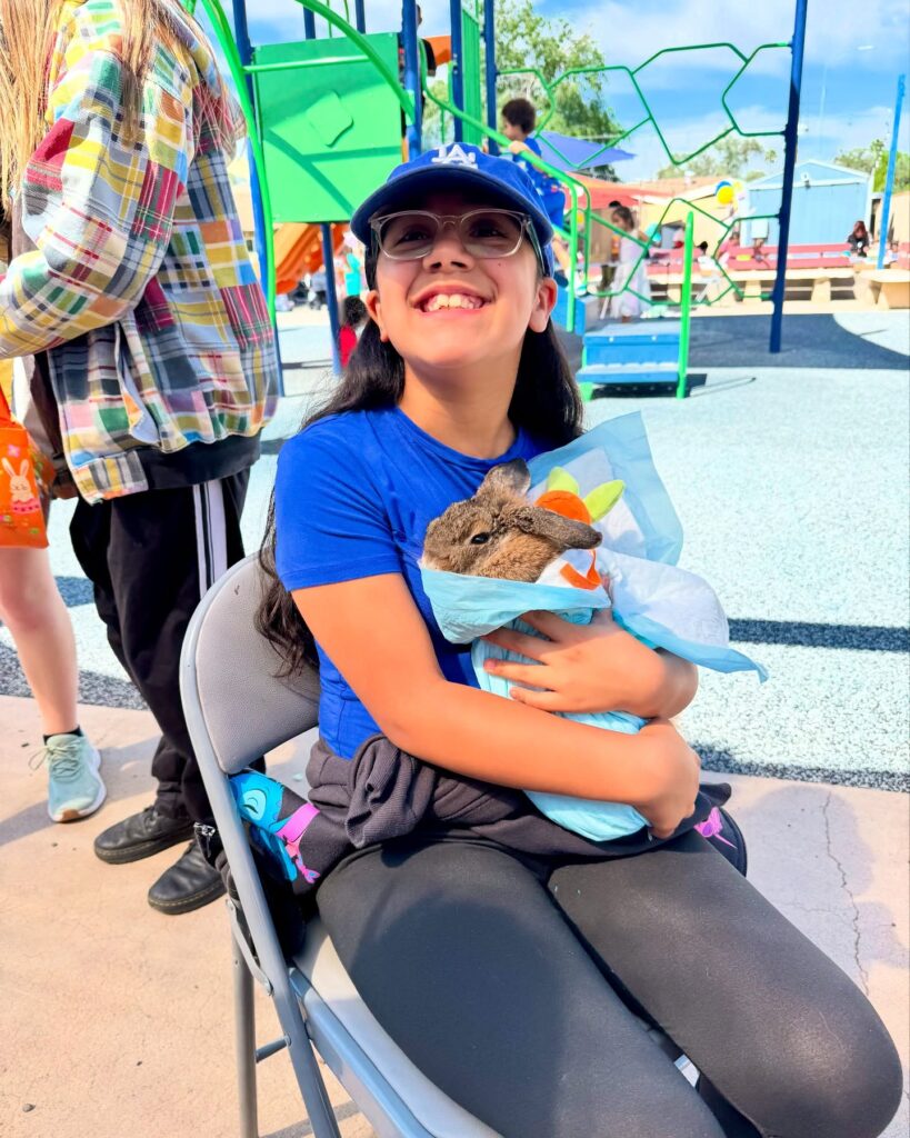 girl holding bunny at maggie's place easter event