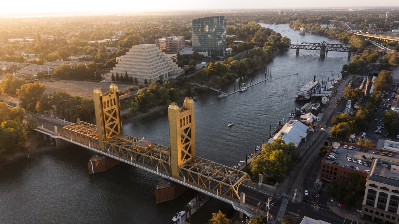 Sunset view of the historic 1935 Tower Bridge and the downtown skyline of Old Sacramento, California, USA.