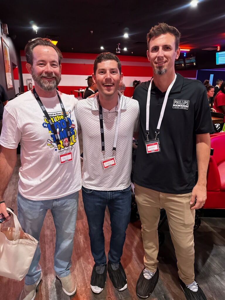 three lawyers pose at Special Olympics Bowl-A-Thon Bash 2025 event, full scale