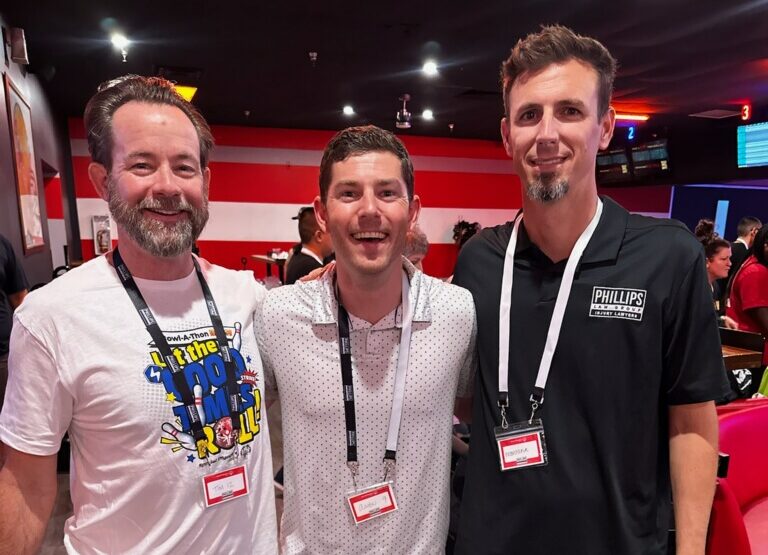 three lawyers from phillips law posing at the Special Olympics Bowl-A-Thon Bash 2025 event