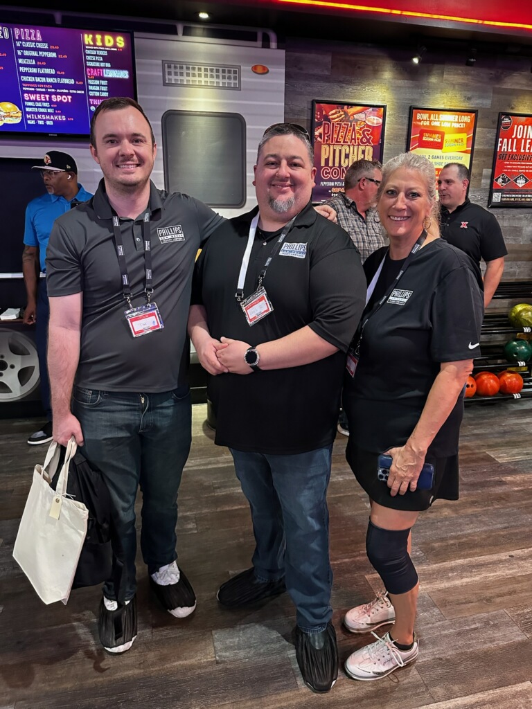 three phillips law group staff members posing at the special olympics bowling event