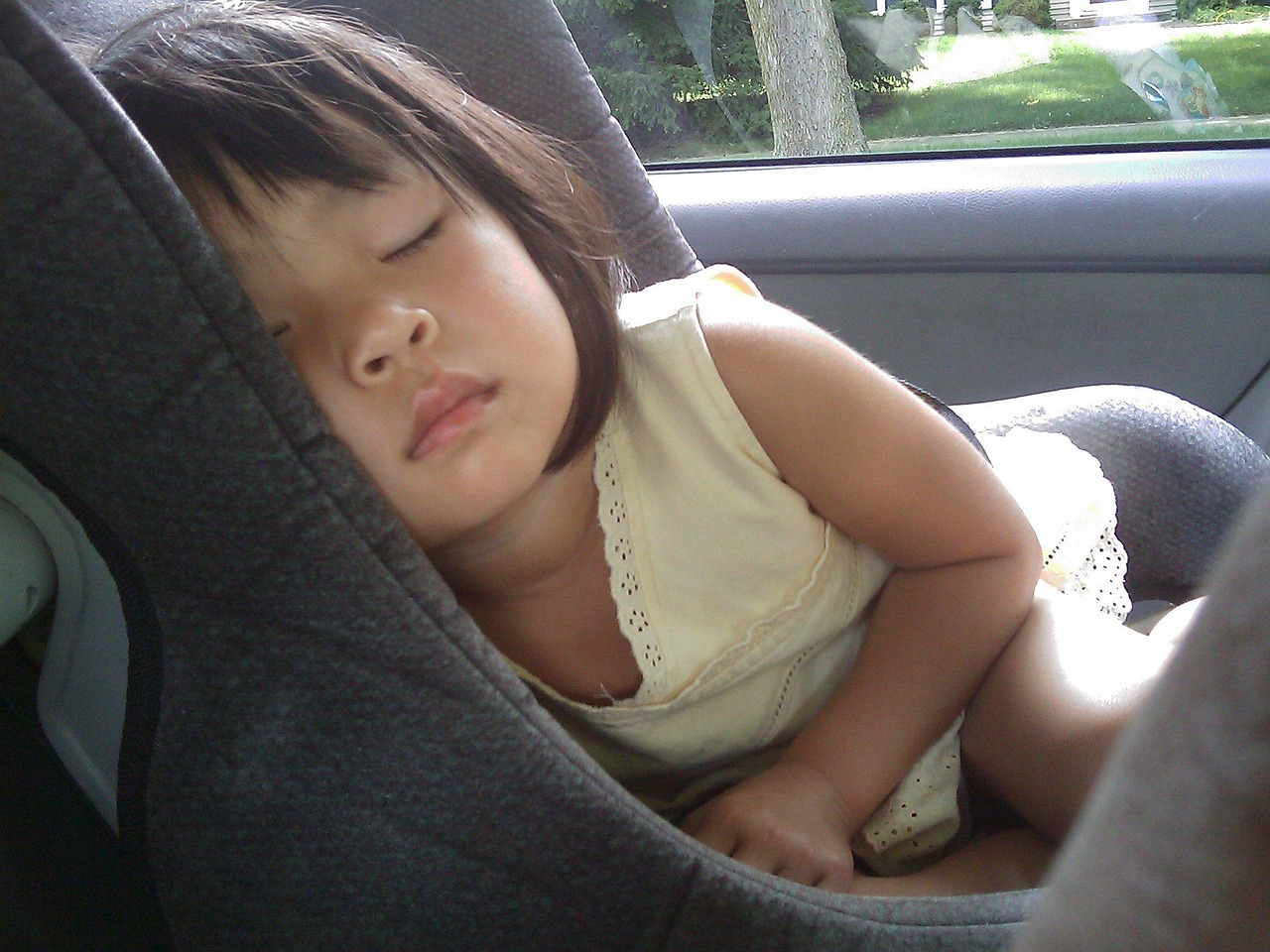 child in back of car sleeping