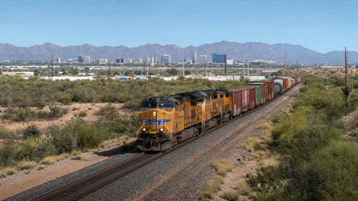 Freight train on tracks passing through Tucson Arizona desert