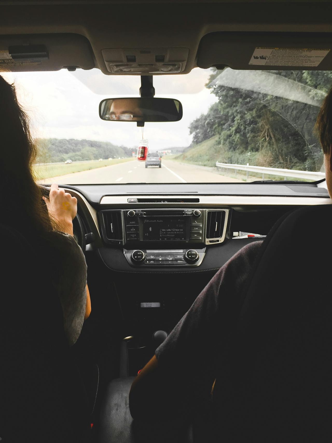 view of driver and passenger from backseat