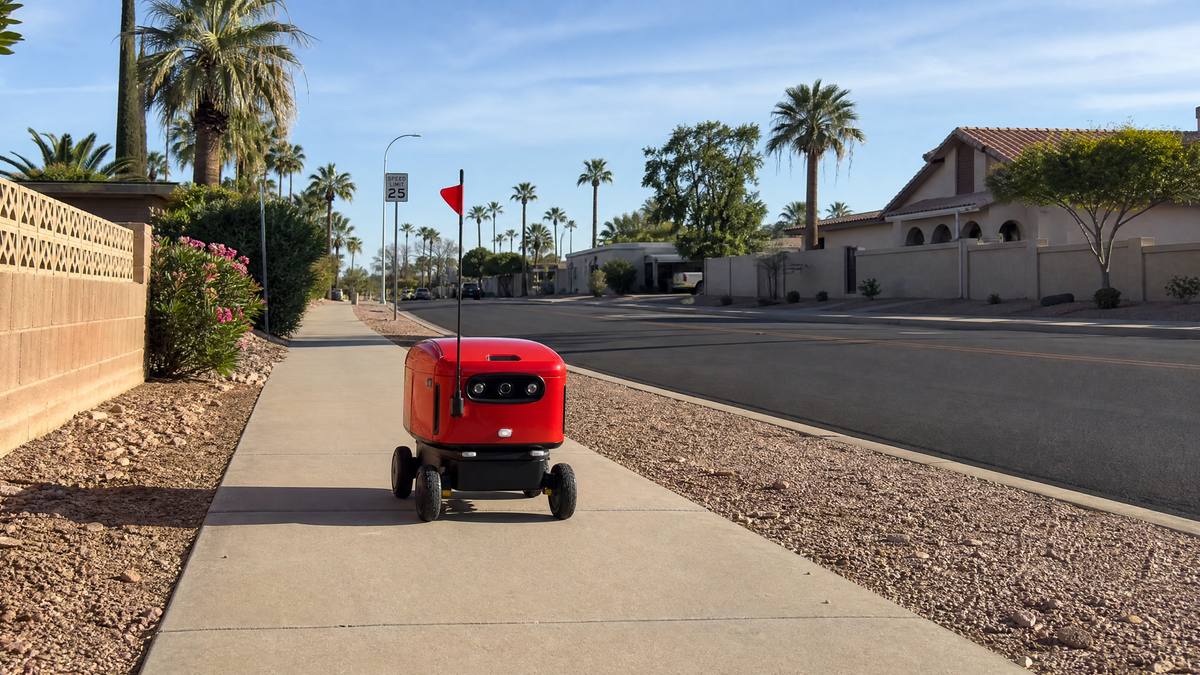 DoorDash autonomous delivery robot Dot on an Arizona suburban sidewalk