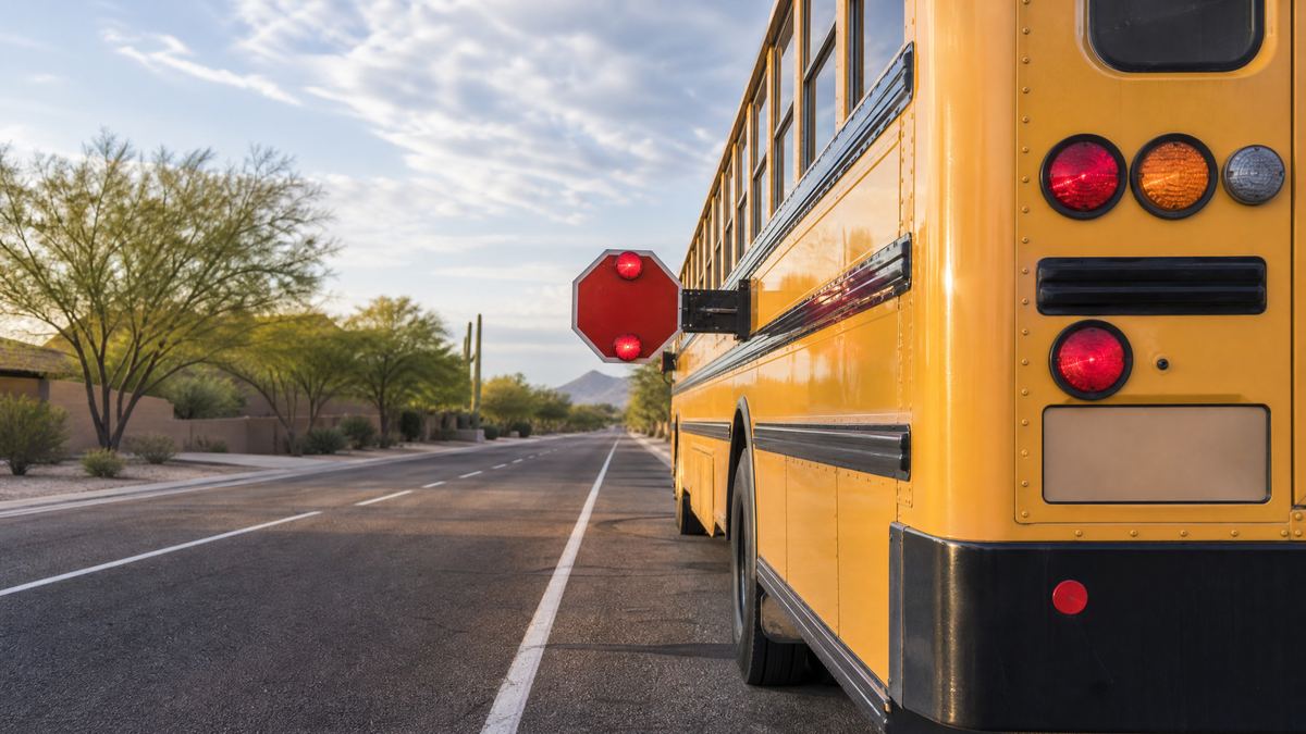 School bus stop arm and flashing safety lights on an Arizona neighborhood street