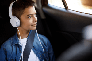 back seat with child listening to headphones