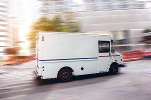 postal worker traveling in mail truck