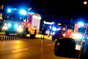 emergency vehicles on overpass at night
