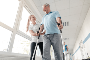 physical therapist helping patient with walking
