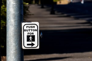 image of crosswalk push button at night