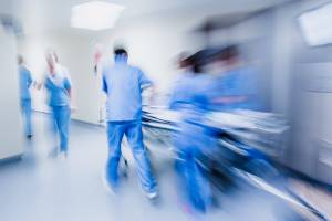 doctors rushing gurney through hallway