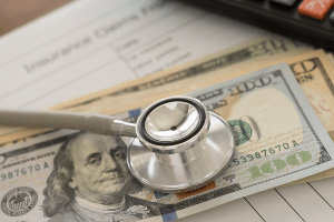 table with medical bills below money