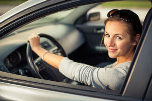 woman driving car with one hand