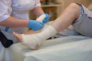 nurse wrapping up an ankle